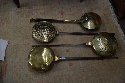 Lot 582 - A group of four antique brass, steel and...