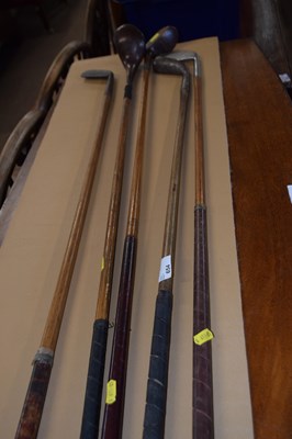 Lot 654 - A group of five antique golf clubs