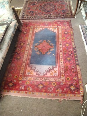 Lot 458 - A Turkish red ground floor rug decorated with...