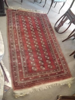 Lot 720 - A 20th Century Bocara type red floor rug with...
