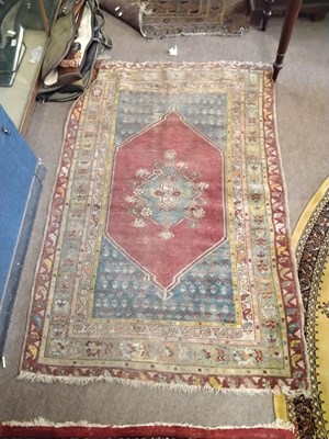 Lot 727 - An antique Middle Eastern wool floor rug...
