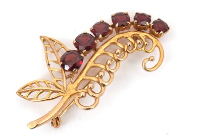 Lot 162 - A 9ct garnet brooch, the stylised leaf set...