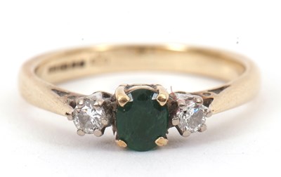 Lot 124 - A 9ct emerald and diamond ring, the central...