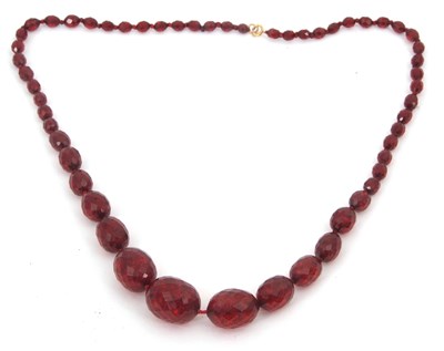 Lot 265 - An amber bead necklace, the oval faceted amber...