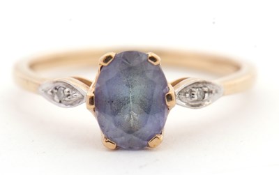 Lot 46 - A 9ct topaz and white stone ring, the oval...