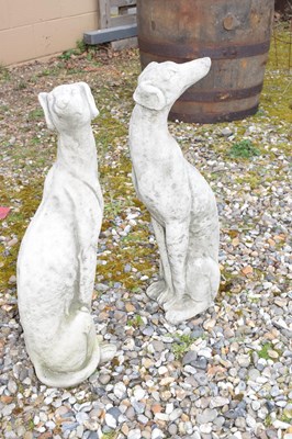 Lot 16 - Pair of small composite seated whippets,...