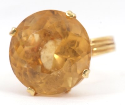 Lot 53 - A citrine dress ring, the round citrine,...