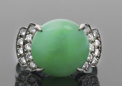 Lot 405 - A 14K jade and diamond ring, the round jade...