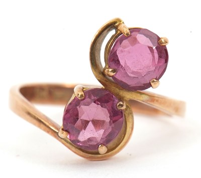 Lot 129 - A 9ct gemset ring, set with two round pink...
