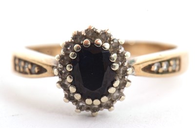 Lot 119 - A 9ct sapphire and diamond cluster ring, the...