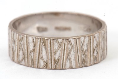 Lot 230 - An 18ct wedding band, 7mm deep with all around...