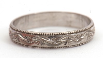 Lot 113 - An 18ct wedding band, with all around...