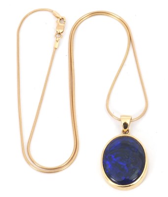 Lot 154 - An 18ct black opal pendant and 9ct chain, the...
