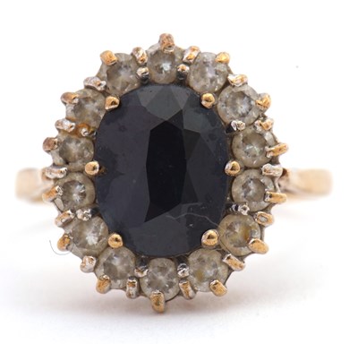 Lot 116 - A 9ct sapphire and CZ cluster ring, the oval...