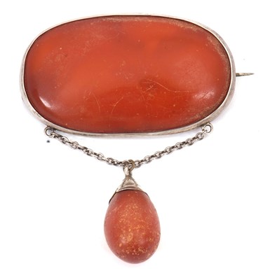 Lot 270 - An amber brooch, the large oval amber cabochon,...