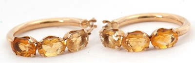 Lot 171 - A pair of citrine earhoops, the hoops set with...