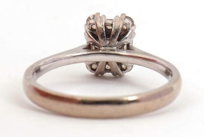 Lot 81 - A diamond cluster ring, set with emerald,...