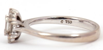 Lot 81 - A diamond cluster ring, set with emerald,...