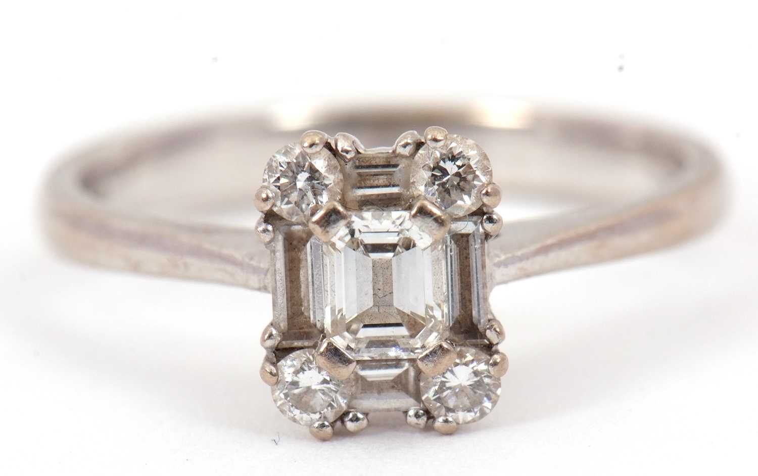 Lot 81 - A diamond cluster ring, set with emerald,...