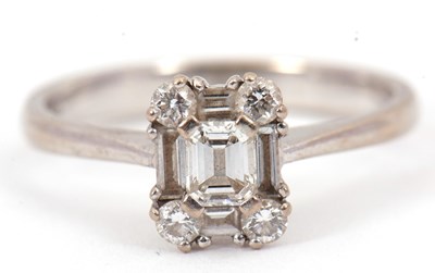 Lot 81 - A diamond cluster ring, set with emerald,...