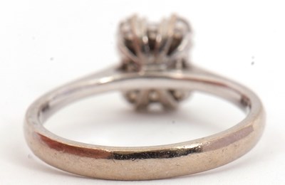 Lot 81 - A diamond cluster ring, set with emerald,...