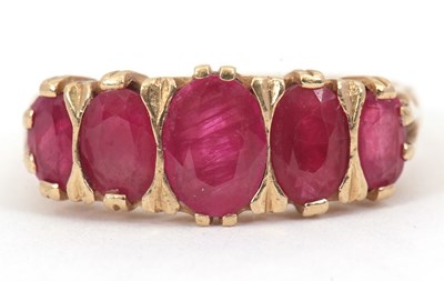 Lot 83 - A 9ct ruby ring, set with five graduated oval...