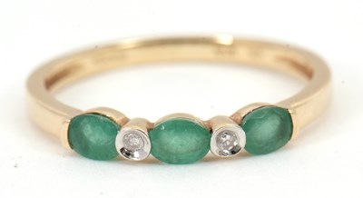 Lot 89 - A 9ct emerald and diamond ring, set with three...