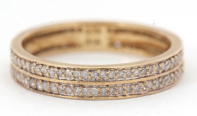 Lot 57 - A 9ct diamond eternity ring, set with two...