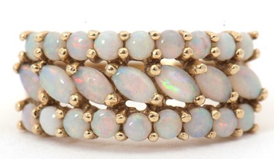 Lot 110 - A 9ct opal ring, set with a central band of...