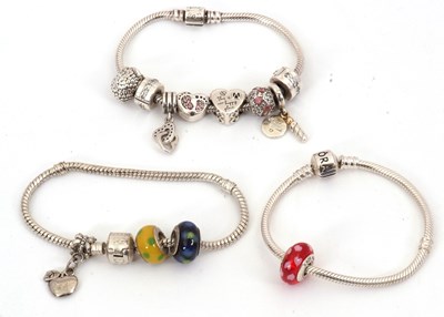 Lot 272 - Three Pandora charm bracelets, (3)