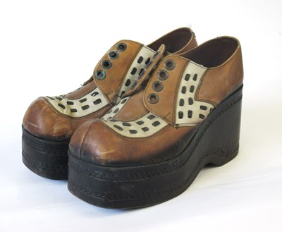 Lot 141 - A pair of 1970's platform shoes, the brown and...