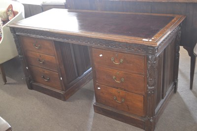 Lot 401 - A Victorian Gothic oak twin pedestal office...