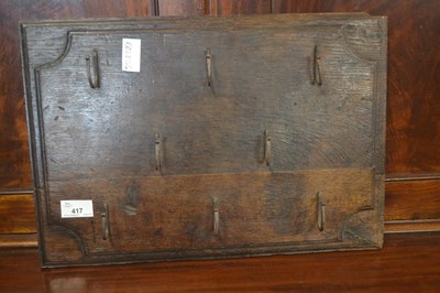 Lot 417 - An oak key rack with iron hooks, 31 x 44cm