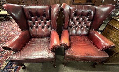 Lot 475 - A pair of button back red leather wing back...