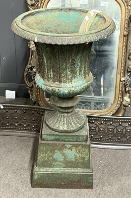 Lot 520 - A green painted cast iron garden urn and...