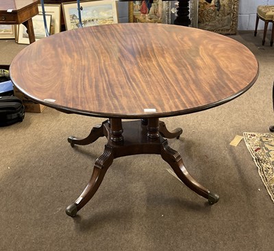 Lot 555 - A Georgian mahogany dining table, the oval top...