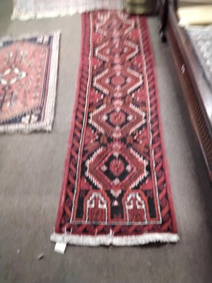 Lot 488 - A small Afghan runner carpet decorated with...