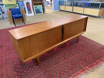 Lot 119 - A mid Century teak sideboard with sliding...