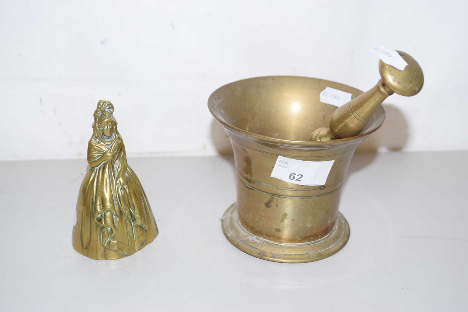 Lot 62 - A brass pestle and mortar and a brass bell