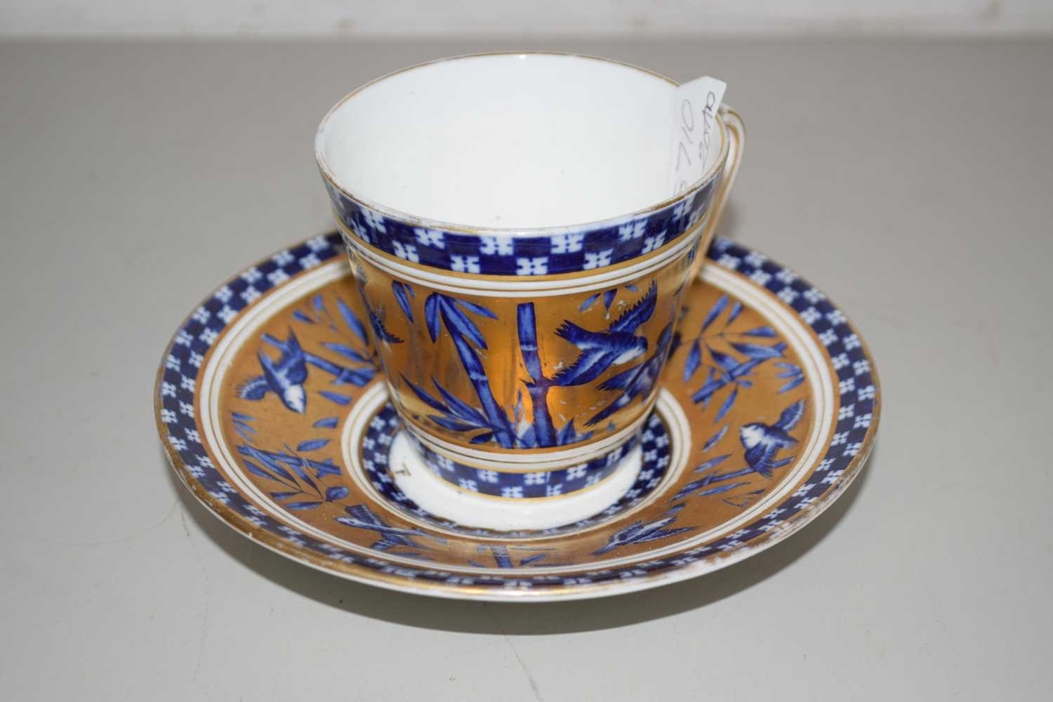 Lot 48 - A Coalport gilt decorated cup and saucer
