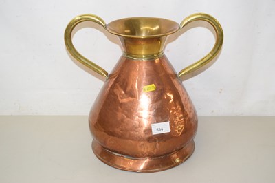Lot 534 - A copper and brass handled pot