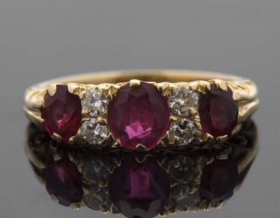 Lot 412 - A ruby and diamond ring, with three graduated...