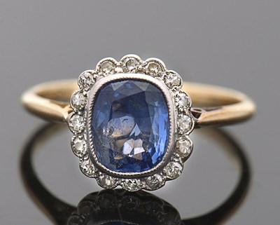 Lot 398 - An 18ct sapphire and diamond ring, the central...