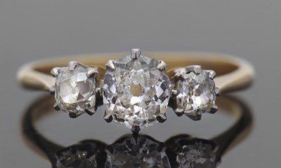 Lot 408 - A three stone diamond ring, set with three old...