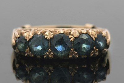 Lot 404 - A 9ct green sapphire ring, the five graduated...