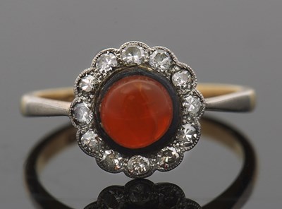 Lot 422 - An 18ct and platinum orange stone and diamond...