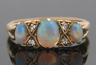 Lot 396 - An opal and diamond ring, with three graduated...