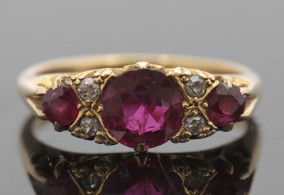 Lot 417 - An 18ct ruby and diamond ring, with three...