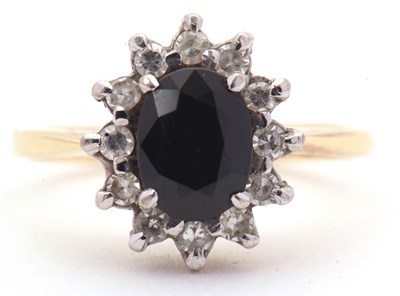 Lot 3 - An 18ct sapphire and diamond cluster ring, the...