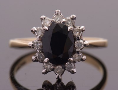 Lot 3 - An 18ct sapphire and diamond cluster ring, the...